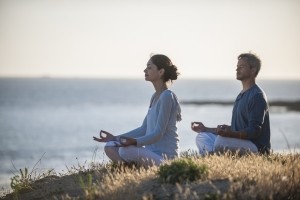 A person and person sitting on a rock looking at each other Description automatically generated with low confidence